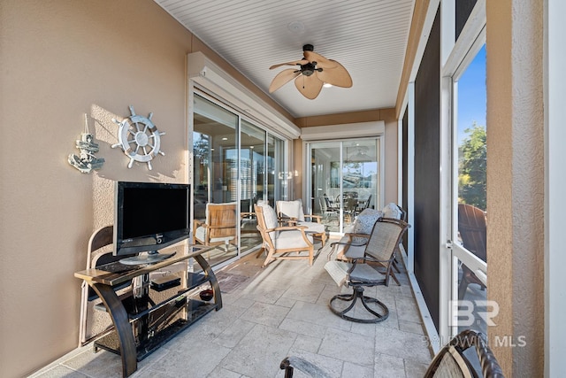 sunroom / solarium with ceiling fan and a healthy amount of sunlight