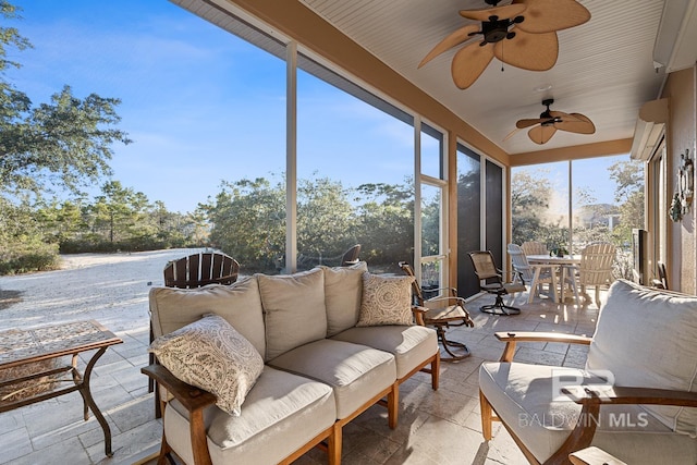 sunroom featuring ceiling fan