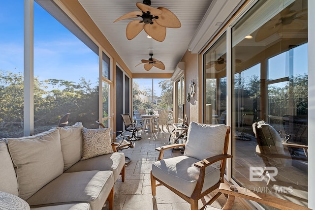 sunroom / solarium with a wealth of natural light and ceiling fan