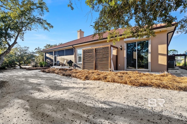 back of house with a sunroom