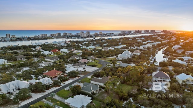 aerial view at dusk with a water view