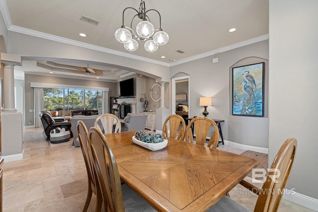 dining room featuring ceiling fan with notable chandelier, ornate columns, and crown molding