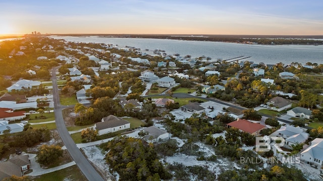 aerial view at dusk with a water view