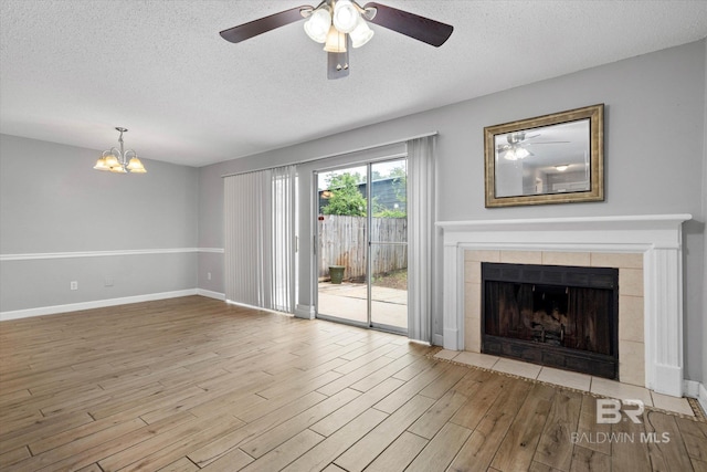6701 Dickens Ferry Rd Unit 40, Mobile, AL 36608 - unfurnished living room featuring wood finished floors, a textured ceiling, a ceiling fan, a chandelier, and baseboards