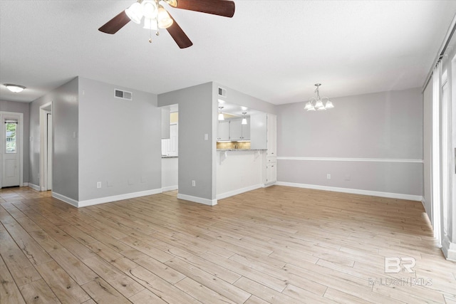6701 Dickens Ferry Rd Unit 40, Mobile, AL 36608 - unfurnished living room with a chandelier, ceiling fan, light wood-type flooring, and baseboards