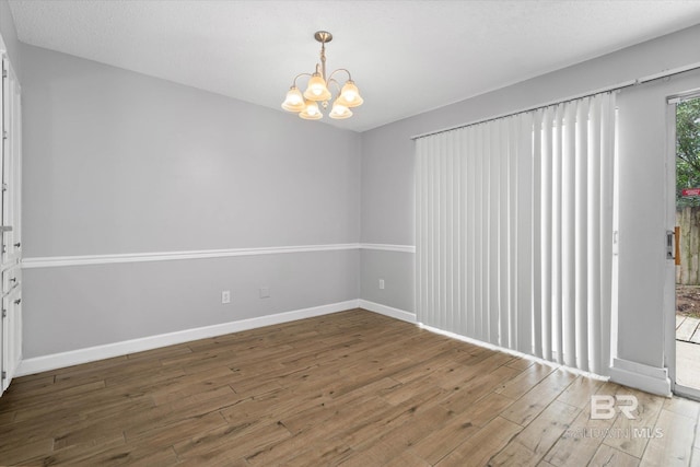 6701 Dickens Ferry Rd Unit 40, Mobile, AL 36608 - empty room with wood finished floors, a chandelier, and baseboards