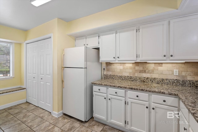 6701 Dickens Ferry Rd Unit 40, Mobile, AL 36608 - kitchen featuring freestanding refrigerator, white cabinets, decorative backsplash, baseboards, and light tile patterned floors