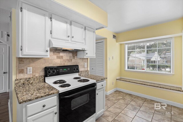 6701 Dickens Ferry Rd Unit 40, Mobile, AL 36608 - kitchen with electric range oven, ventilation hood, tasteful backsplash, white cabinetry, and baseboards