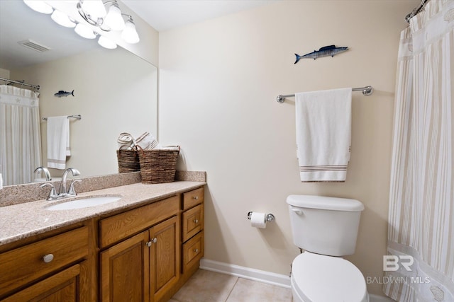 bathroom featuring tile flooring, toilet, and vanity