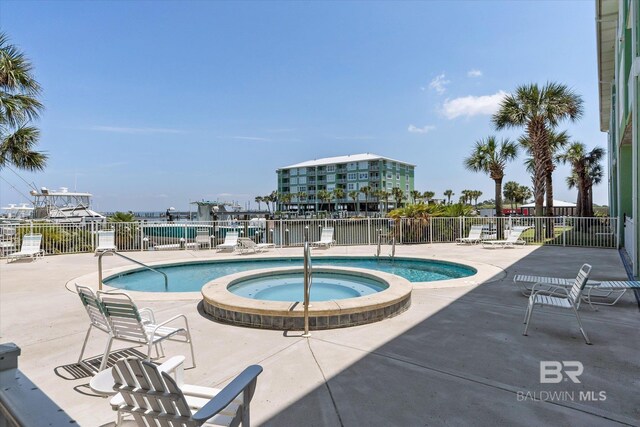 view of swimming pool featuring a patio area and a community hot tub