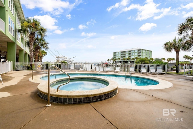 view of pool featuring a community hot tub and a patio area