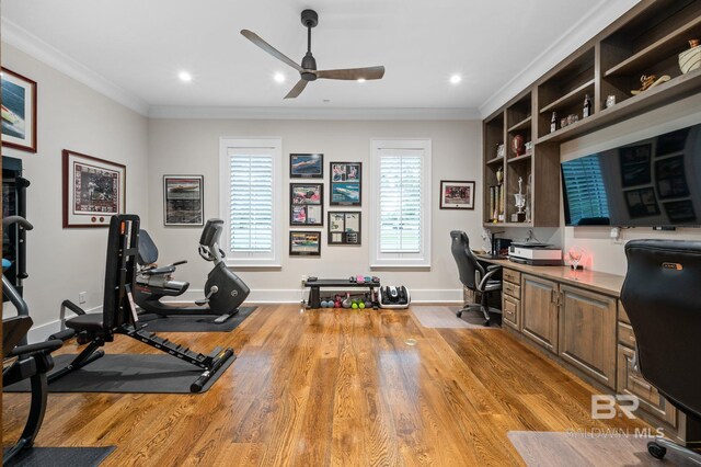 office featuring built in study area, baseboards, a ceiling fan, and wood finished floors