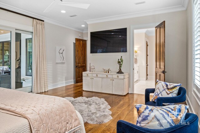 bedroom with crown molding, access to outside, baseboards, wood finished floors, and a skylight