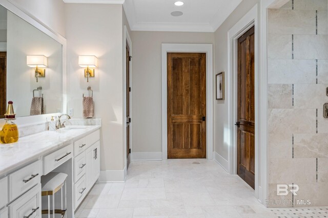 full bath with baseboards, ornamental molding, tiled shower, and vanity