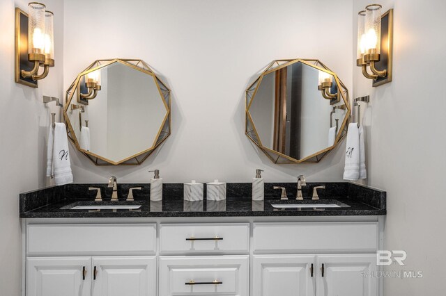 bathroom featuring a sink and double vanity