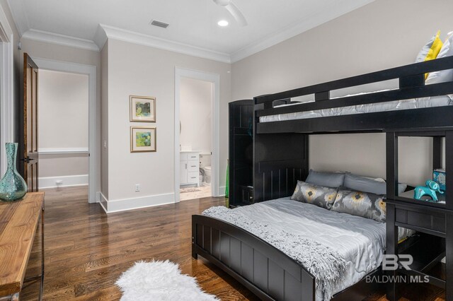 bedroom featuring baseboards, visible vents, ornamental molding, and wood finished floors