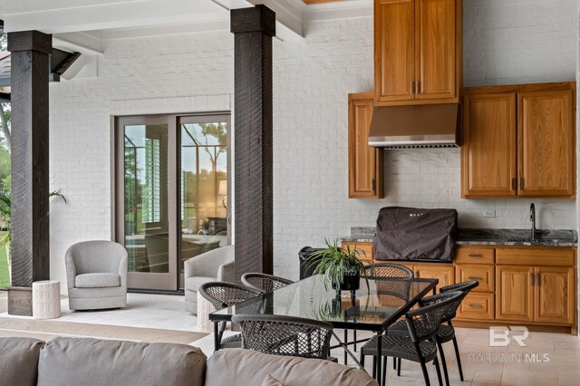 interior space featuring outdoor dining space, a sink, and area for grilling