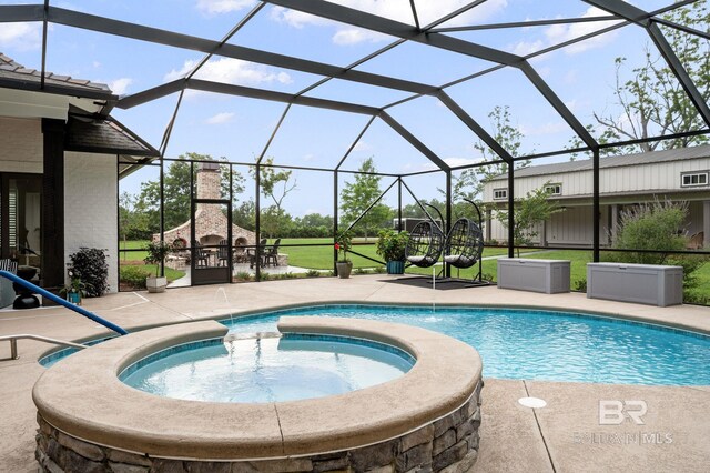 pool with a fireplace, glass enclosure, a patio area, and an in ground hot tub
