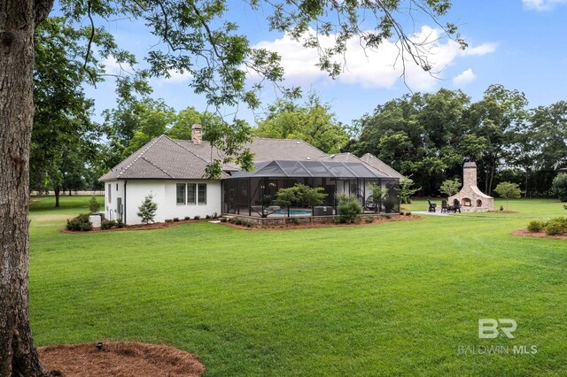 back of house with a lawn, a fireplace, a chimney, and roof with shingles
