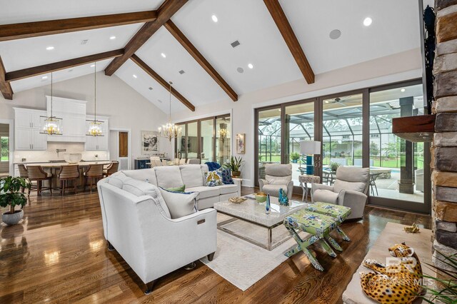 living room featuring dark wood-style flooring, visible vents, high vaulted ceiling, beamed ceiling, and an inviting chandelier