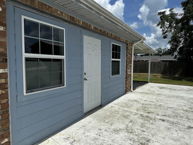 view of exterior entry featuring a patio area