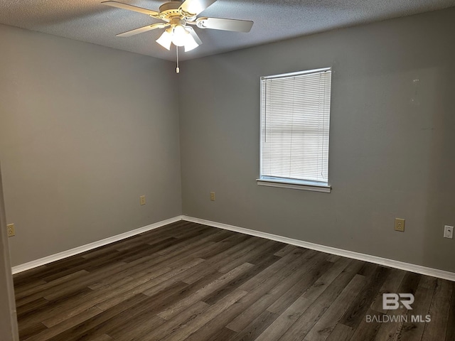 spare room with ceiling fan, dark wood-type flooring, and a textured ceiling