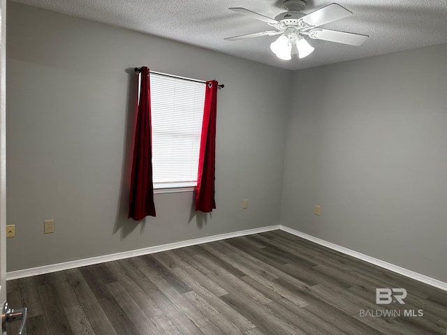 spare room with dark hardwood / wood-style flooring, ceiling fan, and a textured ceiling