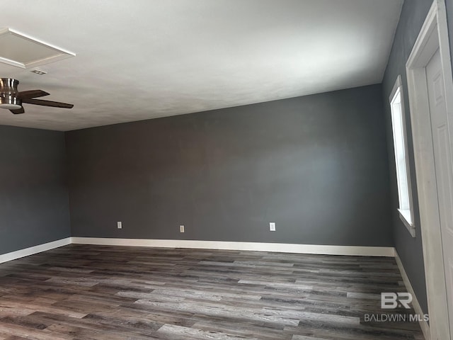 spare room featuring dark wood-type flooring and a healthy amount of sunlight