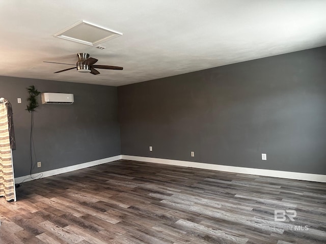 spare room with dark wood-type flooring, a wall mounted air conditioner, and ceiling fan