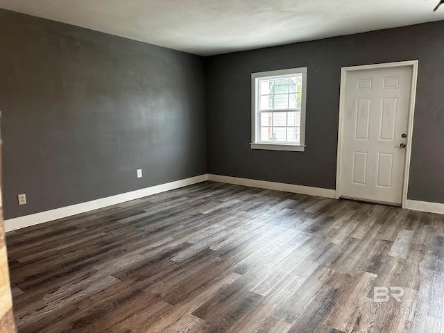 spare room with dark hardwood / wood-style floors