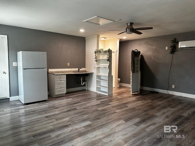 unfurnished living room featuring ceiling fan, dark hardwood / wood-style floors, and an AC wall unit