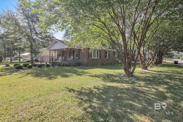 view of yard featuring covered porch