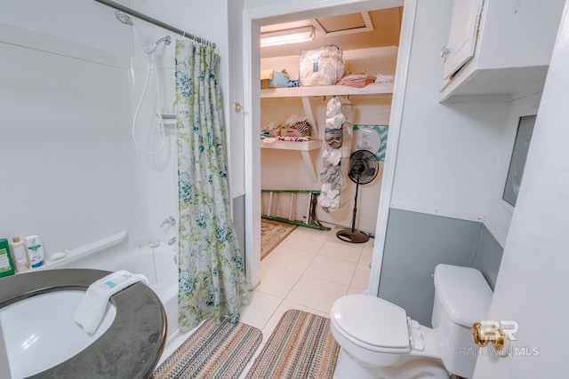bathroom with shower / bath combo with shower curtain, toilet, and tile patterned flooring
