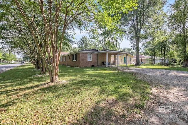 ranch-style house featuring fence, brick siding, crawl space, a front lawn, and dirt driveway