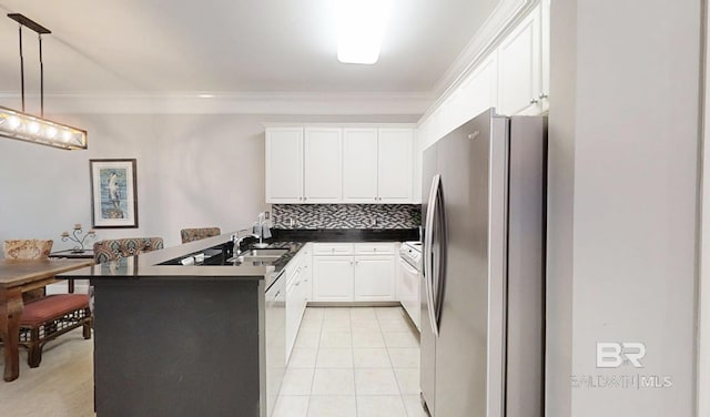 200 Peninsula Blvd Unit A202, Gulf Shores, AL 36542 - kitchen with freestanding refrigerator, a peninsula, ornamental molding, dark countertops, and white cabinetry