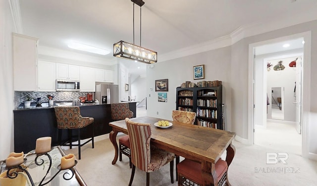 200 Peninsula Blvd Unit A202, Gulf Shores, AL 36542 - dining space featuring light colored carpet, ornamental molding, and recessed lighting