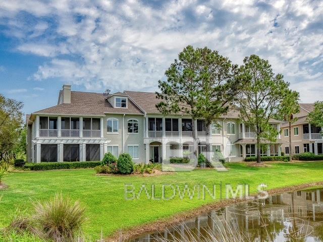 200 Peninsula Blvd Unit A202, Gulf Shores, AL 36542 - rear view of property with a chimney, a lawn, and stucco siding