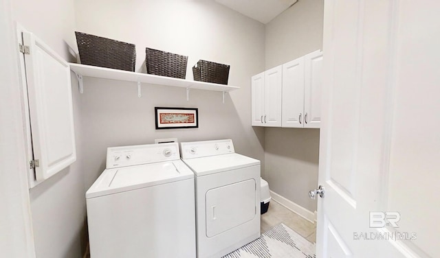 200 Peninsula Blvd Unit A202, Gulf Shores, AL 36542 - laundry room featuring independent washer and dryer, light tile patterned floors, and cabinet space