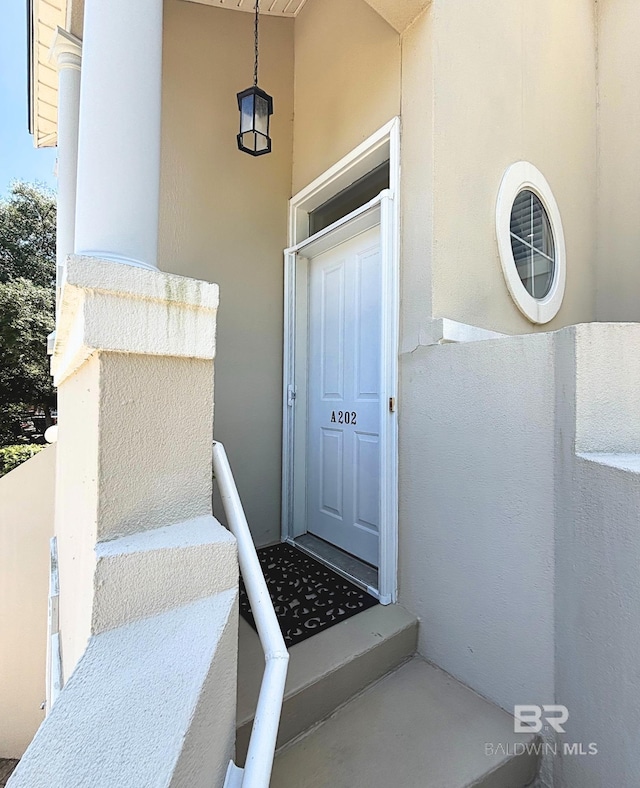 200 Peninsula Blvd Unit A202, Gulf Shores, AL 36542 - doorway to property with stucco siding