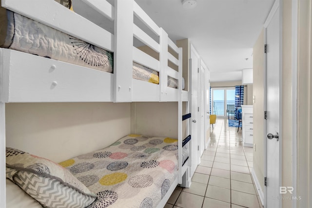 517 E Beach Blvd Unit 5D, Gulf Shores, AL 36542 - bedroom with light tile patterned flooring