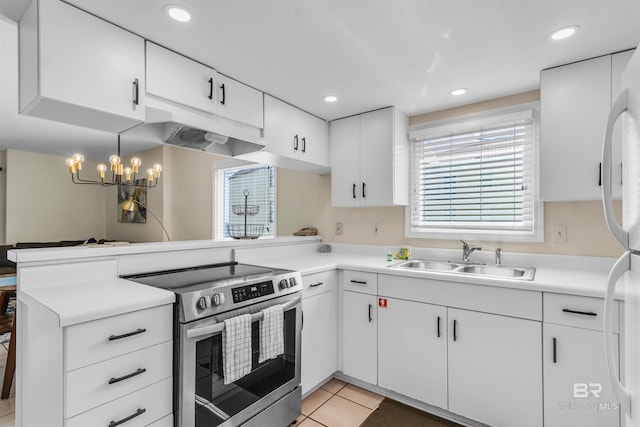 517 E Beach Blvd Unit 5D, Gulf Shores, AL 36542 - kitchen with stainless steel electric range oven, plenty of natural light, a peninsula, white fridge, and recessed lighting