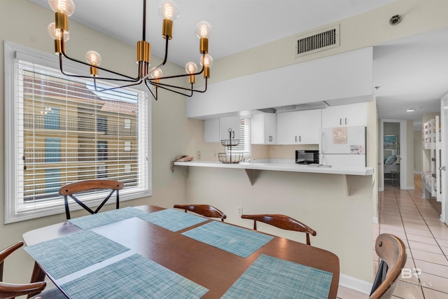517 E Beach Blvd Unit 5D, Gulf Shores, AL 36542 - dining room featuring a chandelier and light tile patterned floors