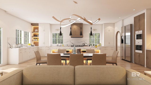 dining room featuring a wealth of natural light and light hardwood / wood-style flooring