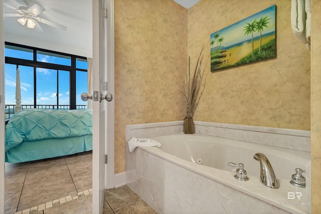 bathroom featuring a bath, ceiling fan, and tile floors