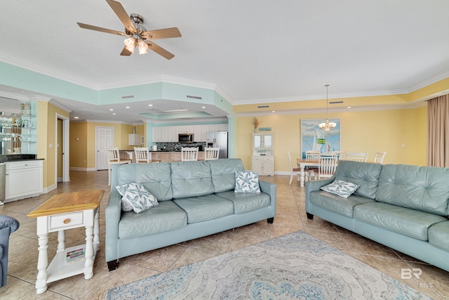 living room with ornamental molding, light tile flooring, and ceiling fan with notable chandelier