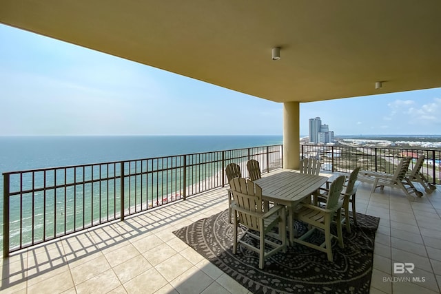 view of terrace with a water view and a balcony