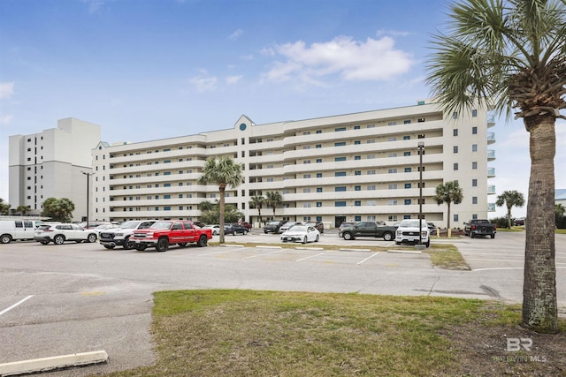 view of building exterior featuring uncovered parking