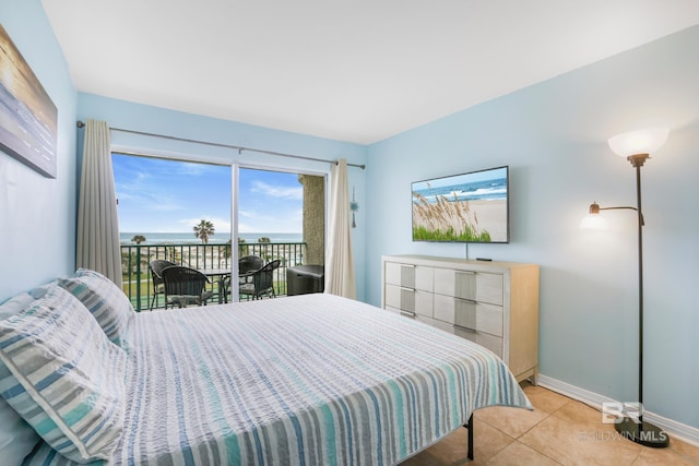 bedroom with light tile patterned floors, access to exterior, and baseboards