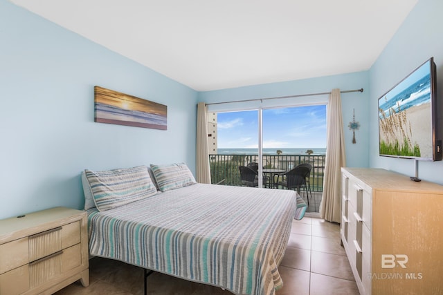 bedroom featuring light tile patterned floors and access to exterior