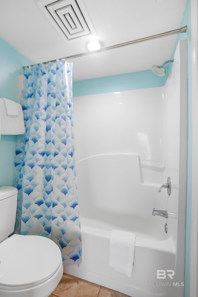 bathroom with visible vents, toilet, shower / tub combo, and tile patterned floors